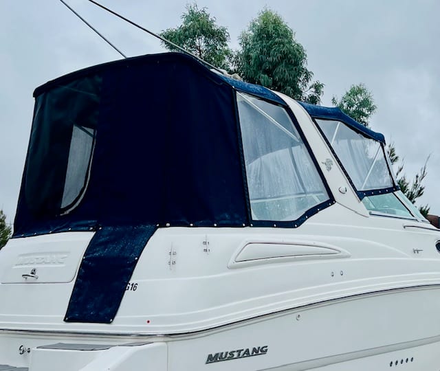Custom navy bimini and canopy with removable clears fitted to a Mustang cabin cruiser by Boat Repairs Melbourne, Braeside VIC
